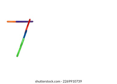 Colorful ice cream sticks arranged in numbers over white background 