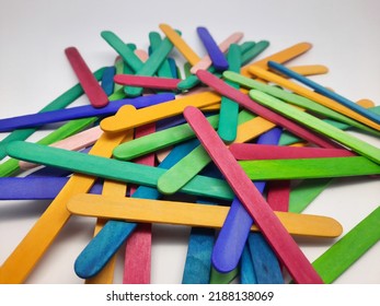 Colorful Ice Cream Sticks From Pine Or Albasia Trees. School Craft Supplies And Materials, Children's Educational Toys From Recycled Colored Ice Cream Sticks. Selective Focus On A White Background.