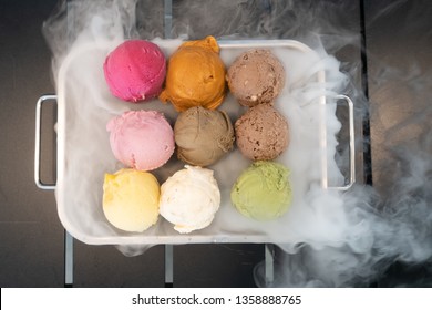 Colorful Ice-cream With Dry Ice In The Black Table 