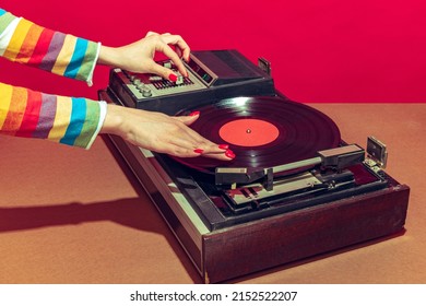 Colorful Image Of Female Hands Spinning Retro Vinyl Record Player Like A Dj Isolated Over Red Background. Bright Design With Vintage Things. Concept Of Pop Art, Fashion, Music, Mix Old And Modernity