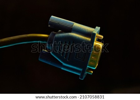 A colorful image of VGA cable transferring data while suspended on a black background