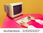 Colorful image of vintage computer monitor and keyboard on bright pink tablecloth over yellow background. Typing information. Concept of retro pop art, vintage things, mix old and modernity