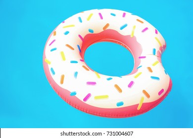 Colorful inflatable donut floating in pool