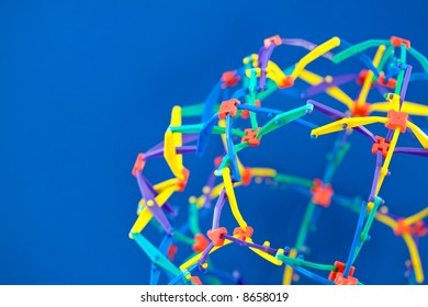 Colorful Interconnected Geometric Structure on a Blue Background - Shutterstock ID 8658019