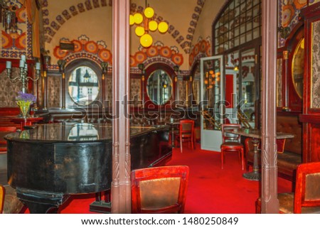
Colorful interior of an empty restaurant in the city center. Sukiennice hall. Cracow, Poland. Downtown earlymorning. Main square in the historic city. Nobody at the tables. Vacation in a royal town.