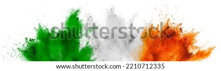 colorful irish tricolour flag in  green white orange color holi paint powder explosion on isolated background. ireland  europe celebration soccer fans travel tourism concept