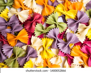 colorful Italian pasta background. Various colors of bow tie farfalle pasta. Top view. - Powered by Shutterstock