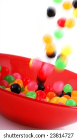 Colorful Jelly Beans Falling Into A Red Bowl.