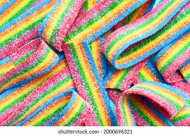 Colorful jelly candies in sugar sprinkles. Sour flavored rainbow candy background. Top view