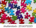 Colorful jigsaw puzzle pieces on white background. Flat lay.