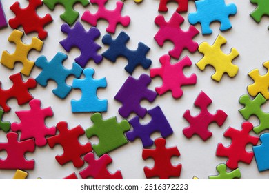 Colorful jigsaw puzzle pieces on white background. Flat lay. - Powered by Shutterstock