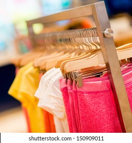 Colorful Kids Clothes Hanging At A Retail Store On Garment Racks