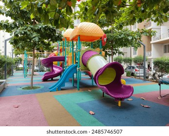 Colorful kids play garden children play area beautiful amenity area in the society clean maintained park amenities swings, sliding and sea saw - Powered by Shutterstock