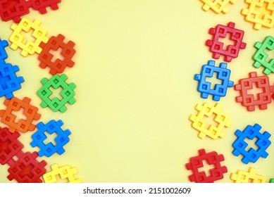 Colorful Kids Toys Border Frame On Yellow Background. Top View. Flat Lay. Copy Space For Text. Concept World Children's Day