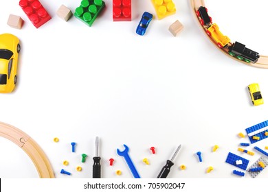 Colorful kids toys frame on white background. Top view. Flat lay.
