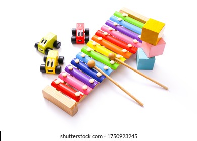 Colorful Kids Toys On White Background. Wooden Cars, Colorful Xylophone And Blocks