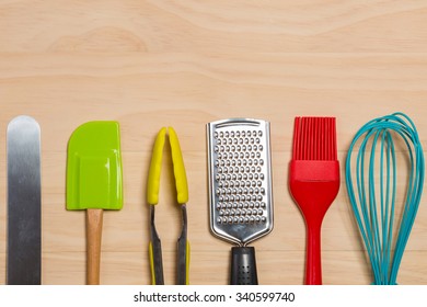 Colorful Kitchen Tools On Wooden  Background