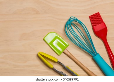 Colorful Kitchen Tools On Wooden  Background