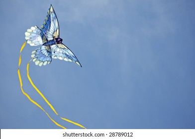 Colorful Kite With Streamers Making A Turn