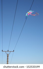 Colorful Kite Trapped In Telegraph Lines