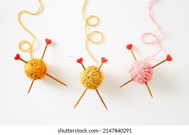 Colorful knitting yarn with needles on white background. Needlework and hobby. DIY concept.