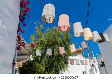 Colorful Lanterns Hang Between Stucco Building On Naxos, Greece