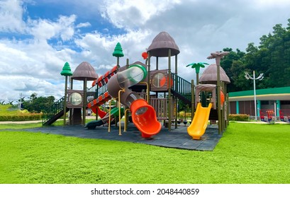 Colorful large playground in the park. Empty modern outdoor playground in summer.