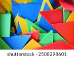 colorful legos, triangular toys and pom-poms