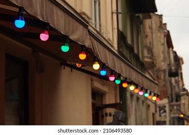 Colorful Light Bulbs. Abstract Blurred Background. Classic Architecture Details. Old Facade With Light Bulb. Decorative External Lighting. Classic Architecture. Exterior Walls Of Old Building. 