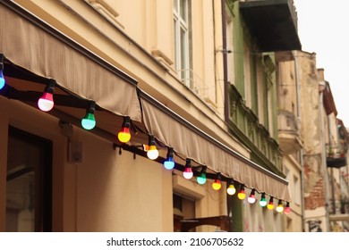 Colorful Light Bulbs. Classic Architecture Details. Old Facade With Light Bulb. Decorative External Lighting. Classic Architecture. Exterior Walls Of Old Building. Ukraine, Lviv.