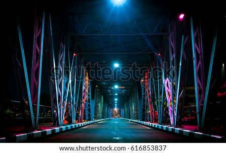 Colorful light on Iron Bridge at night time in Chiang mai, Thailand