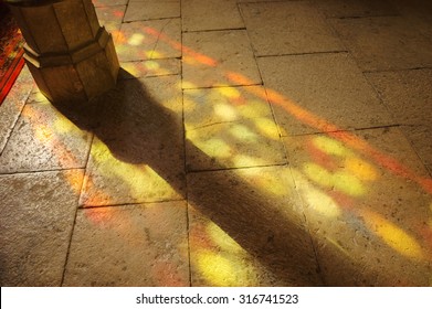 Colorful Light Spots On The The Floor In Church. Sunlight Filtered Through The Stained Glass Window. A Game Of Light And Shadow.