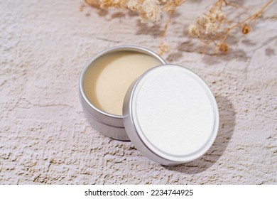 colorful lip balms in round tin cases on light background with shadow overlay, mockup design, label