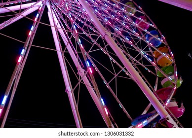 Colorful lit Ferris wheel at night