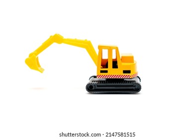 Colorful Little Mini Yellow Plastic Tractor Excavator, Truck, Lorry, Car Toy Isolated On White Background Mockup With Copy Space, Toys For Children, Kids Development, Playing, Childhood Fun.