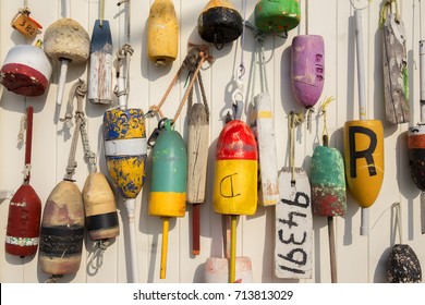 colorful lobster buoys on the wall of the house. buoys hanged on wooden wall