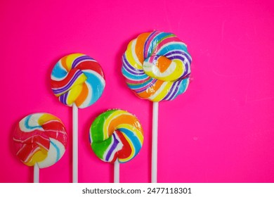 colorful lollipop with different shape, circle, heart, star on pink background