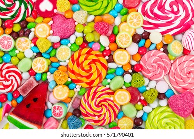 Colorful lollipops and different colored round candy. Top view. - Shutterstock ID 571790401