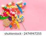 Colorful lollipops and different gummies jelly and candies, top view.