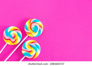 Colorful lollipops on pink background. Candy colored flat lay. Minimal concept for party and childhood. - Shutterstock ID 2083605727