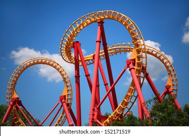 A Colorful Looping Roller Coaster On A Beautiful Sunny Day