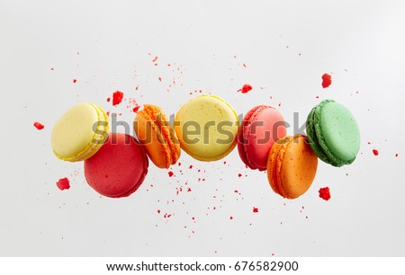 Colorful macarons cakes. Small French cakes. Sweet and colorful french macaroons falling or flying in motion.