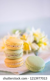 colorful macarons on towel with nice yellow flowers