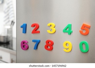 Colorful Magnetic Numbers On Refrigerator Door Indoors