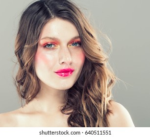 Colorful make-up woman face, beautiful brunette summer makeup, beauty fashion girl model with pink lips. Gray background.