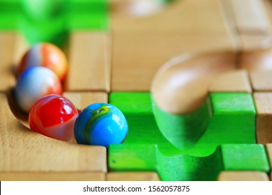 Colorful Marble Run On Wooden Track, Selective Focus