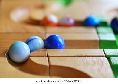 Colorful Marble Run On Wooden Track, Wooden Toy, Selective Focus