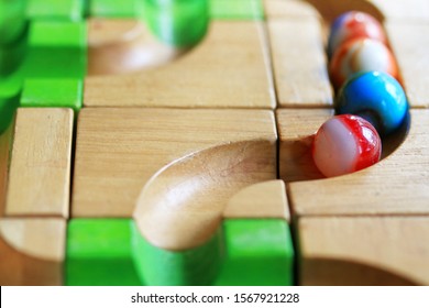 Colorful Marble Run On Wooden Track, Wooden Toy, Selective Focus