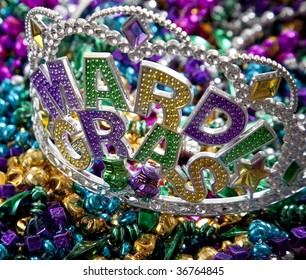 A Colorful Mardi Gras Crown On Top Of A Group Of Colorful Beads