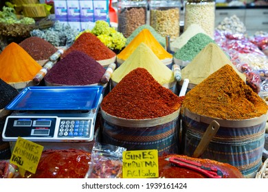 Colorful market counter offering for sale variety of natural spices and herbs, price tags in Turkish